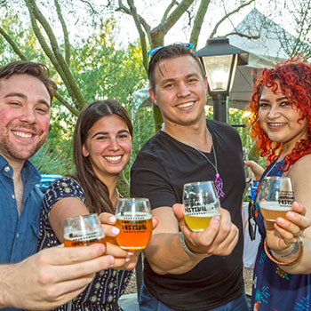 Event attendees raise a glass at the Grapes & Hops Festival