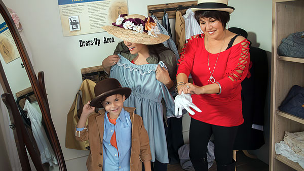 Visitors trying on vintage clothes at the Boomtown 1905 mercantile.